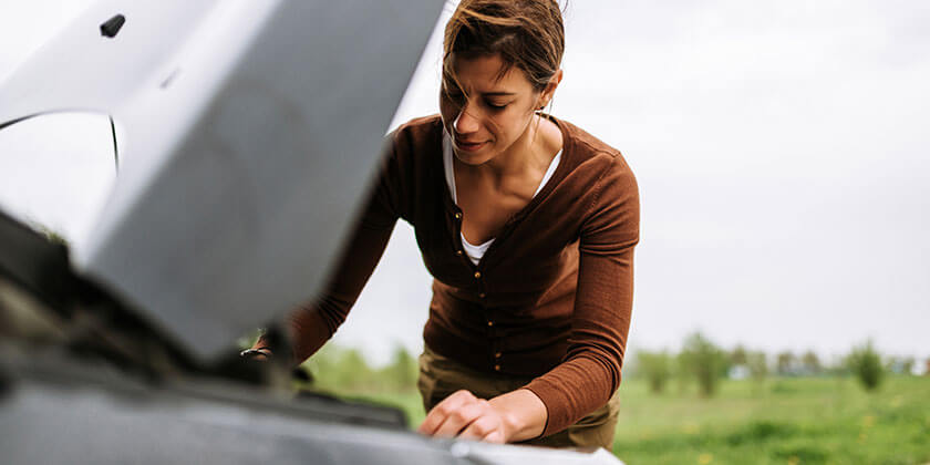 woman broken down car
