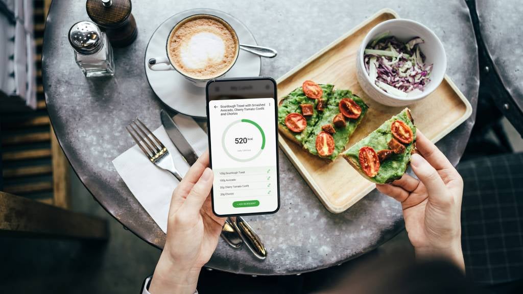 Woman plans meals using her smartphone