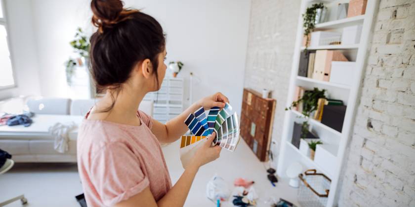 woman choosing wallpaper colours