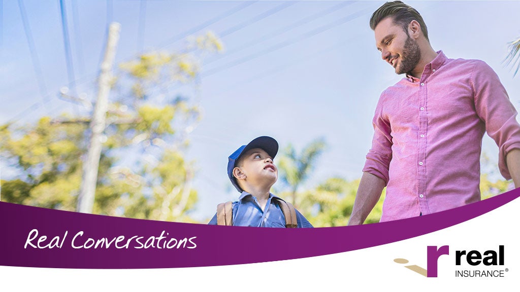 A father and young son look at each other while on the way to school. 