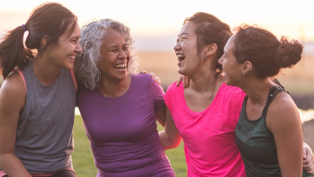 Women of various ages in exercise gear, smiling 