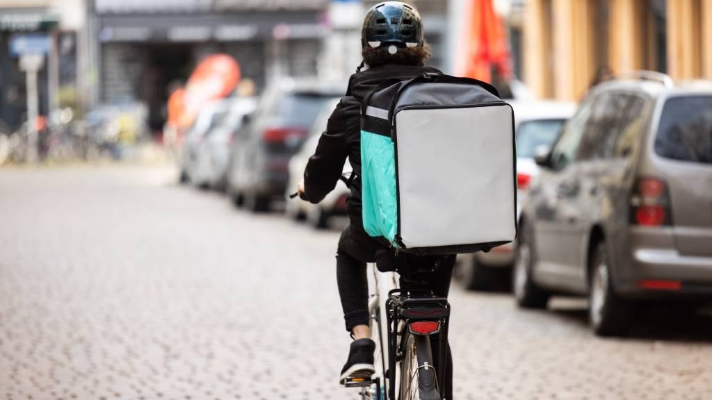 Man rides bicycle as food delivery driver