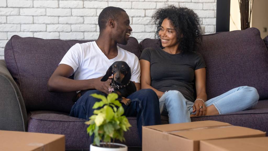 young couple at home with new dog
