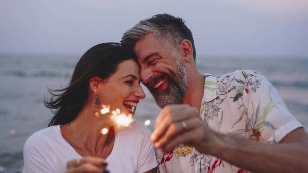 romantic couple in love smiling on beach 