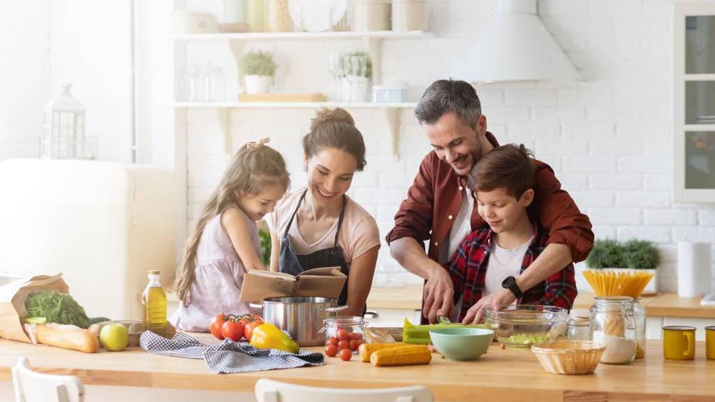 Happy family preparing a meal.