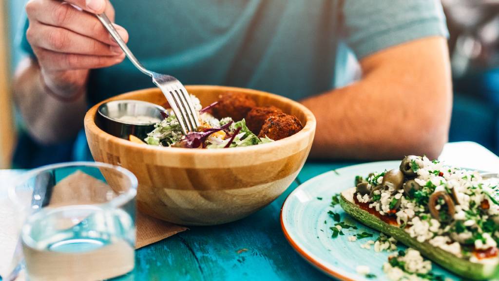 Man eating a bowl of vegan protein food 