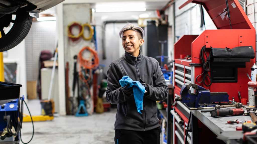 A smiling female mechanic at work