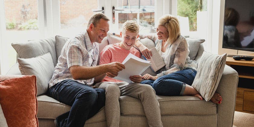 family reading documents on couch