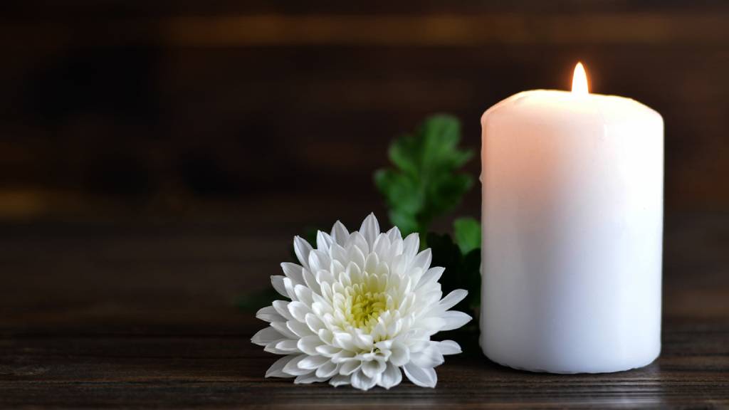 flower and candle at a funeral 