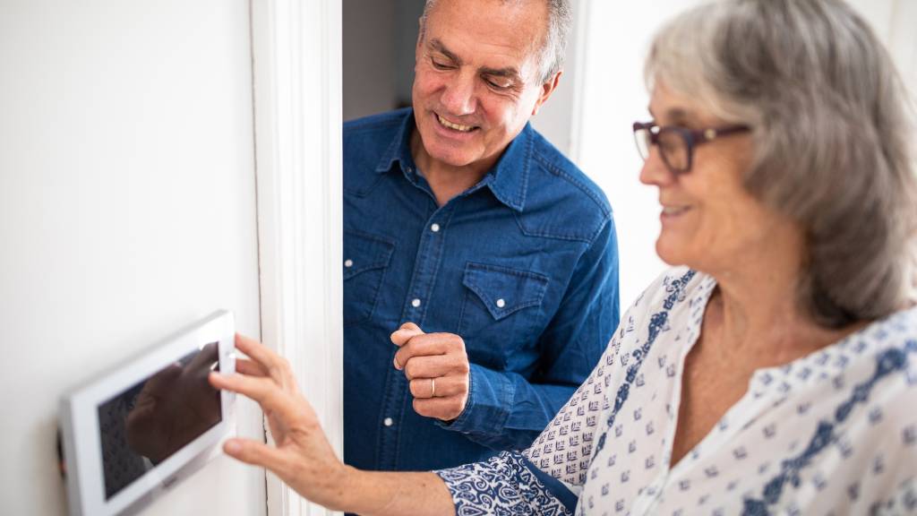 Couple setting a burglar alarm 