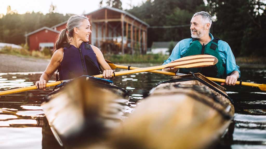 couple in their 50s canoeing 