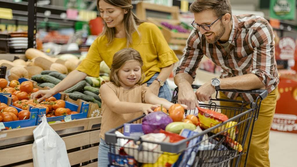 Young family shops at supermarket. 