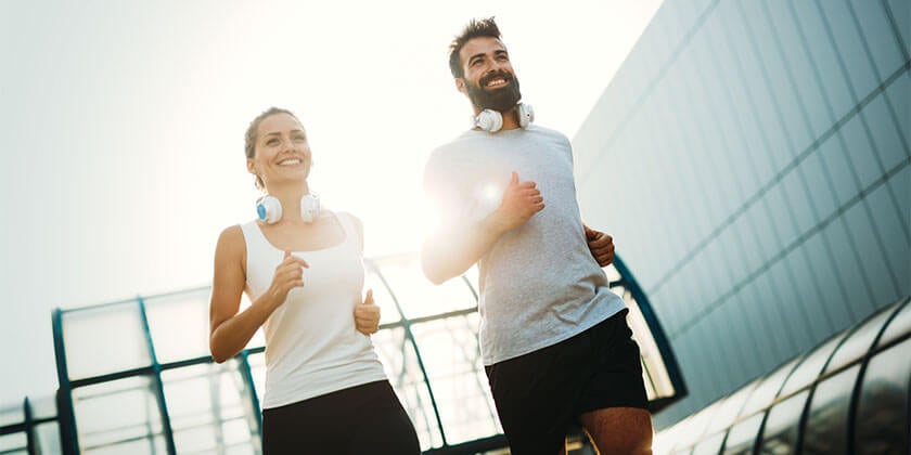 man and woman running together 