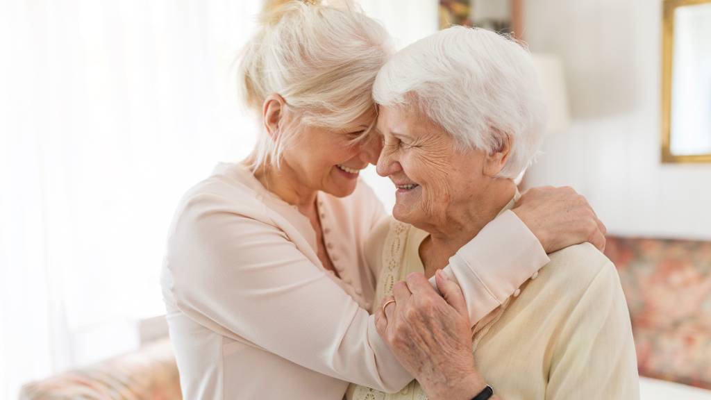 woman and older mother hugging 