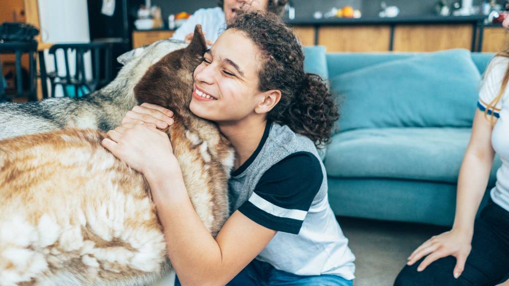 woman saying goodbye to pets before holiday