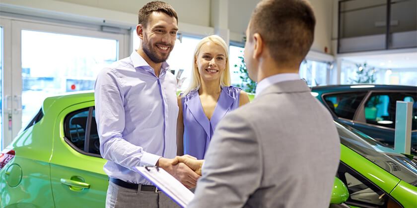 young couple buying new car