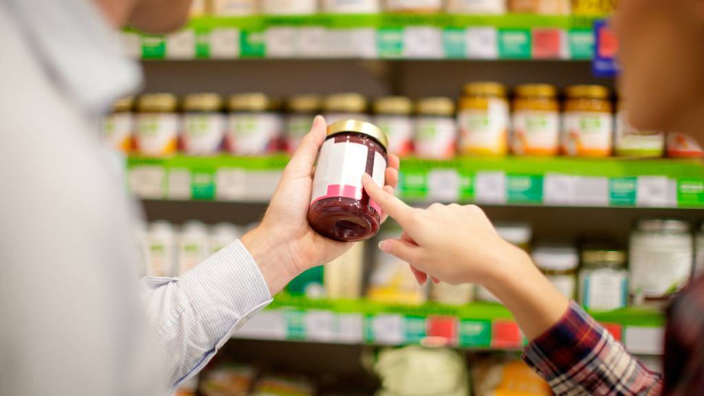 A couple assessing food labels in a supermarket
