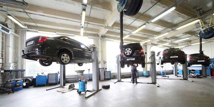 workshop with cars on hoist