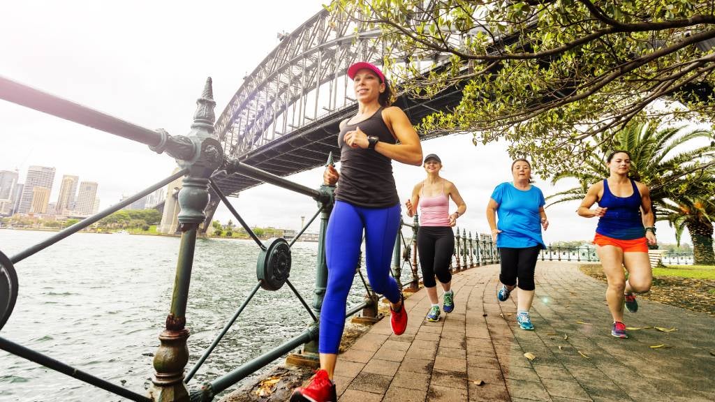 Women in active wear run near Sydney Harbour Bridge