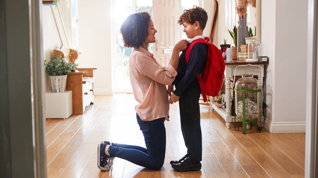 Mother and son getting ready for first day of school