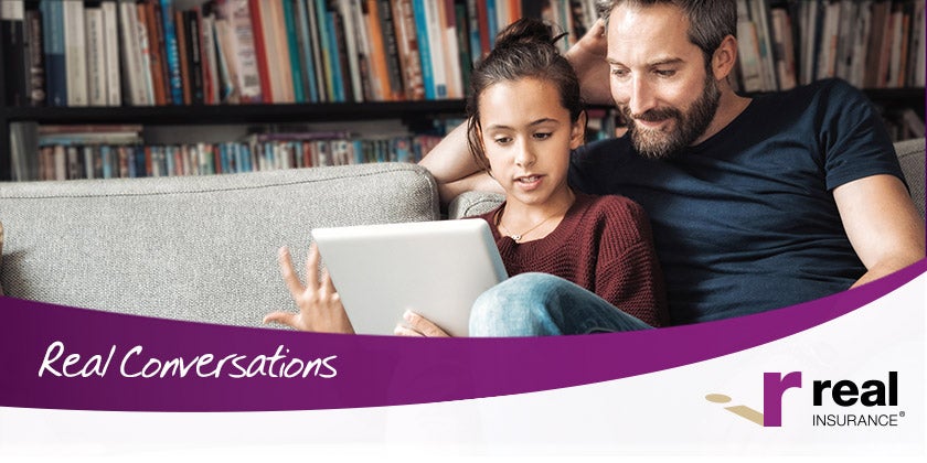 father and child using laptop