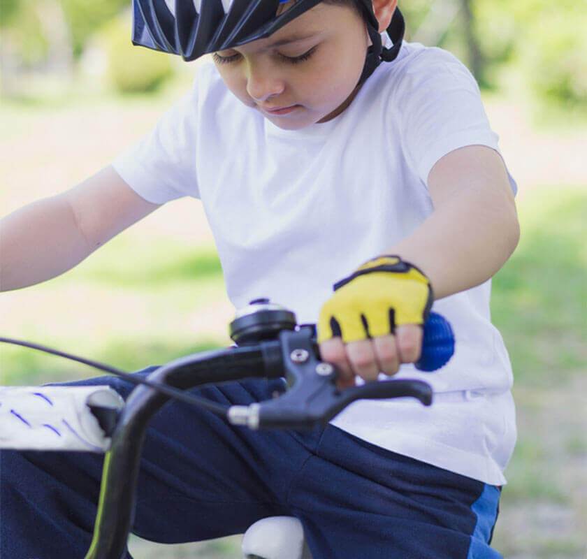 child learning to use pedals on bike