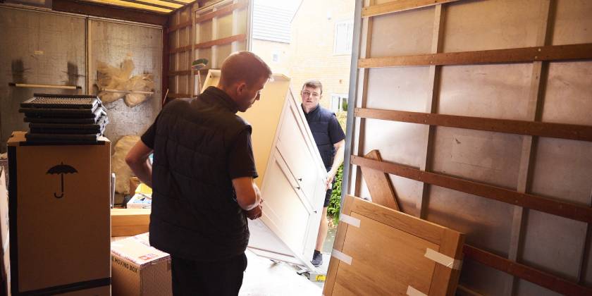 movers loading furniture in truck