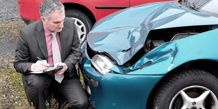 inspecting car accident damage
