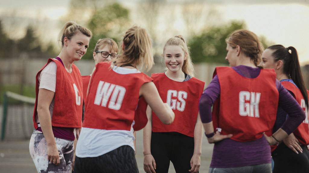 Group of netballers in red bibs