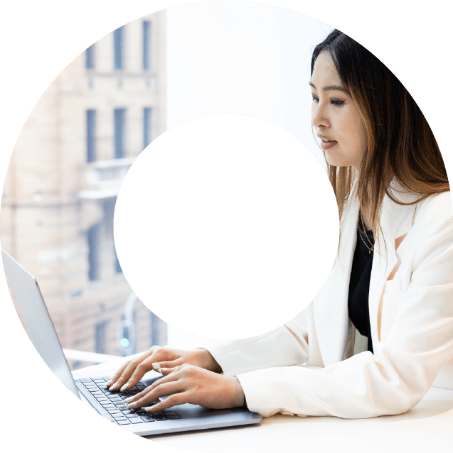 Young woman wearing white suit jacket typing on laptop in viewfinder shape