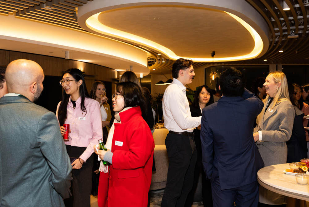 Young people standing and chatting at an business event