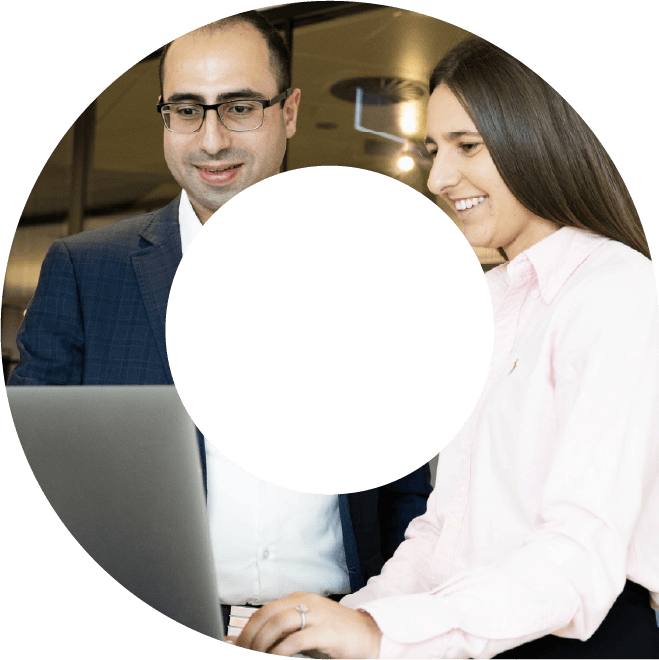 Man and a woman typing on a laptop smiling