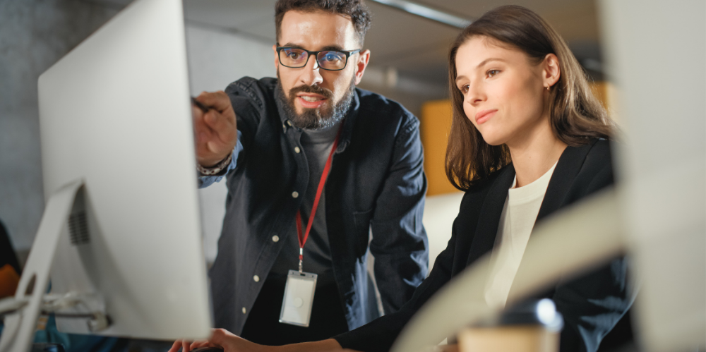 Colleagues discussing project at workplace.