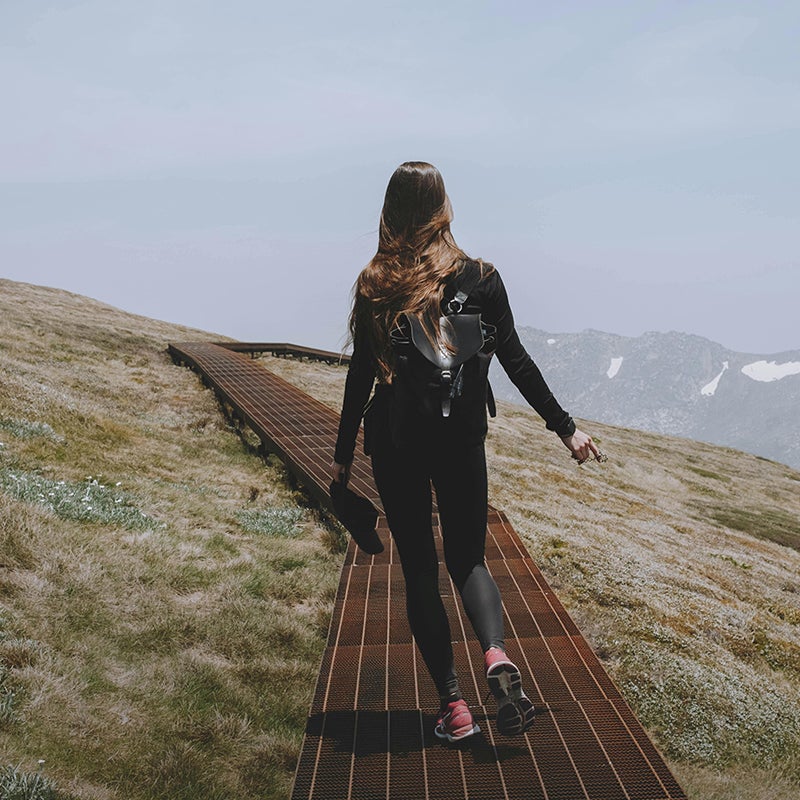 Woman walking on a path through Australian mountains