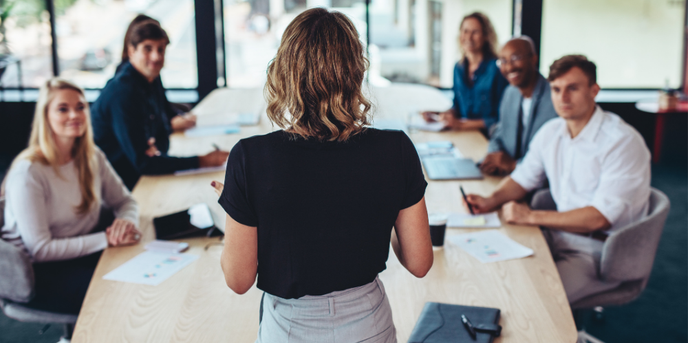 Rear view of a businesswoman addressing a meeting in office