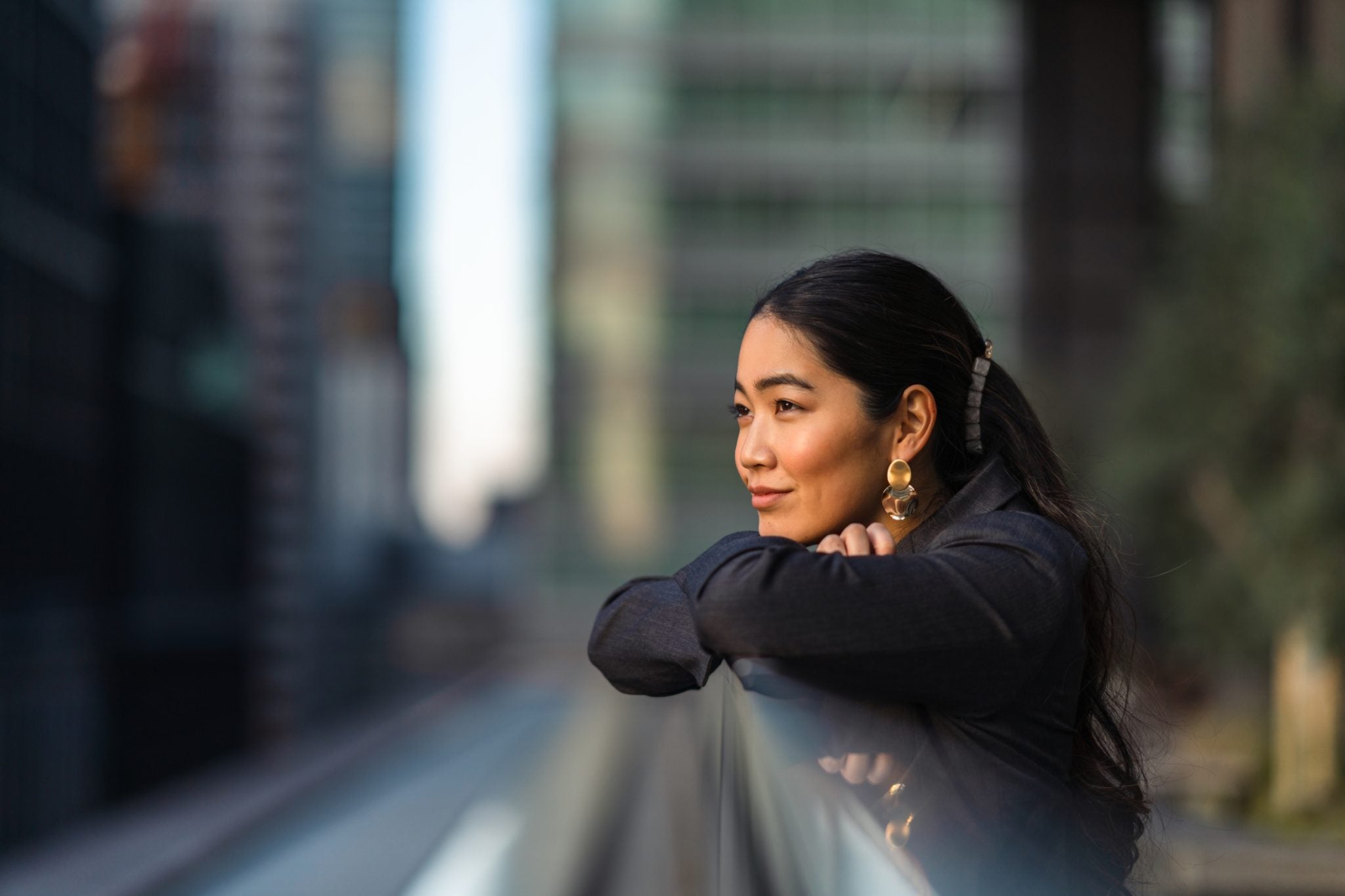 Asian women looking towards a horizion in the city.