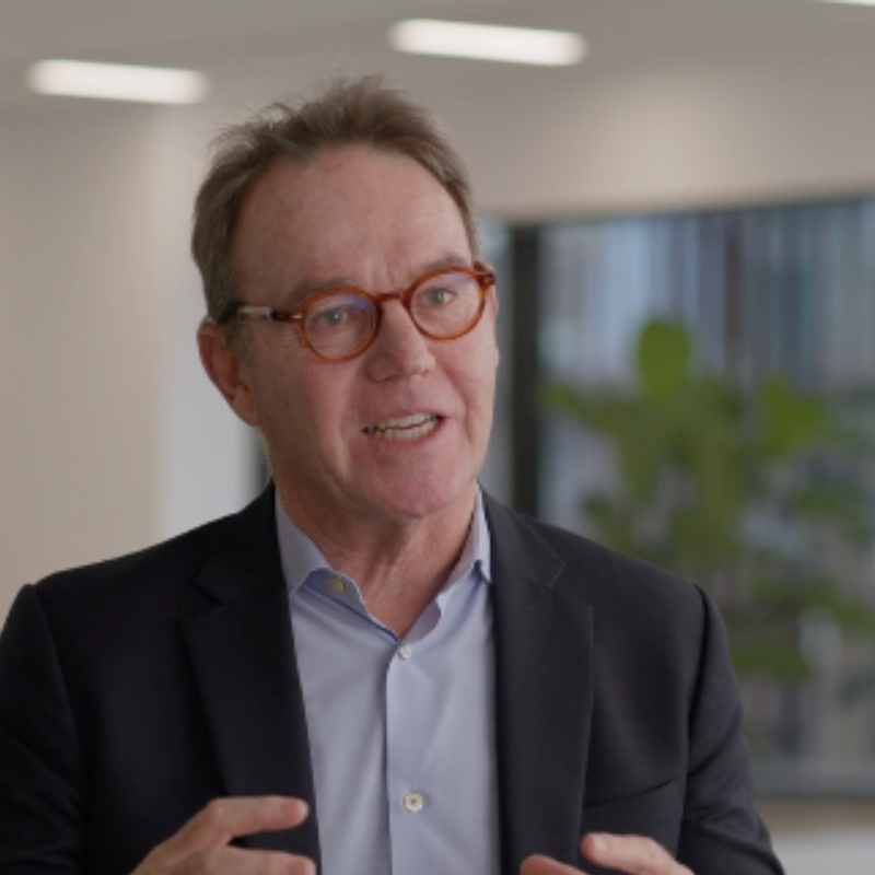 Business man in glasses with red trim talking
