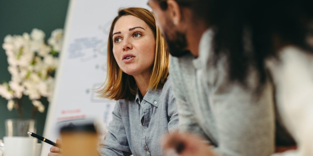 Woman explaining something, or presenting something in a work setting