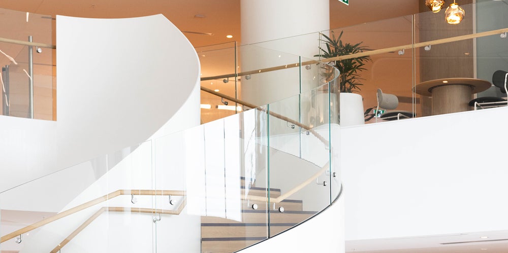 The top of a white and timber staircase.