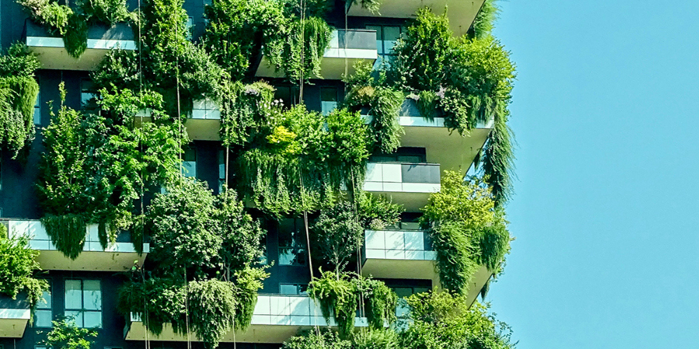 Residential high rise building with green vegetation spilling over all the balconies