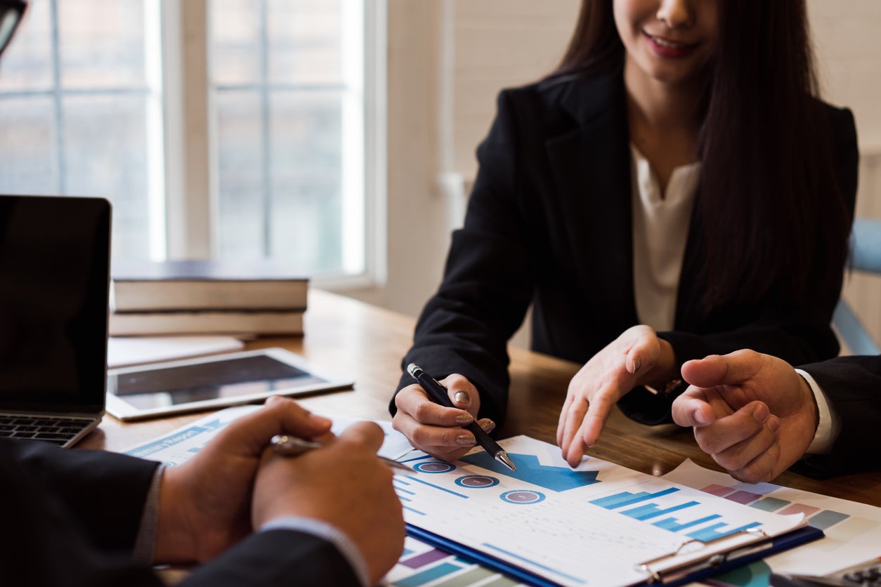 Group of business people discussing Co-investment financial reports.