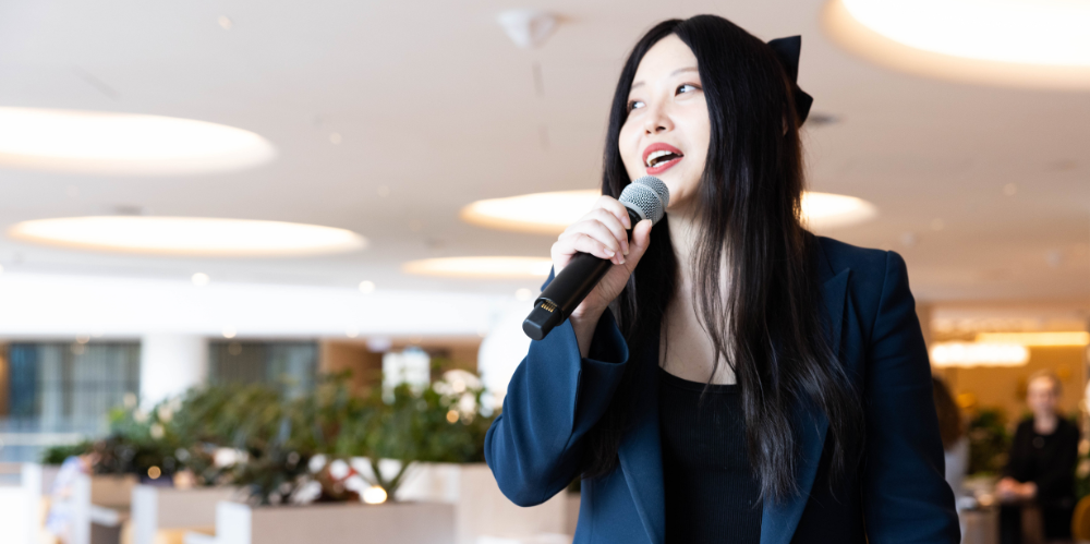 Professional women speaks into microphone.