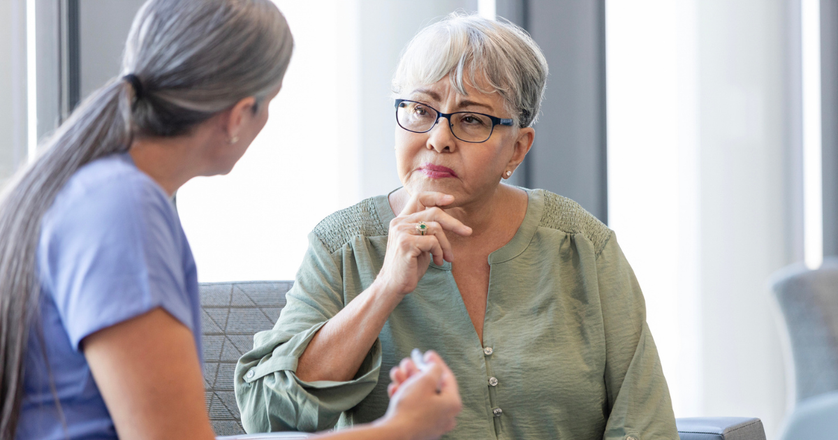 An older woman speaking with a healthcare advisor