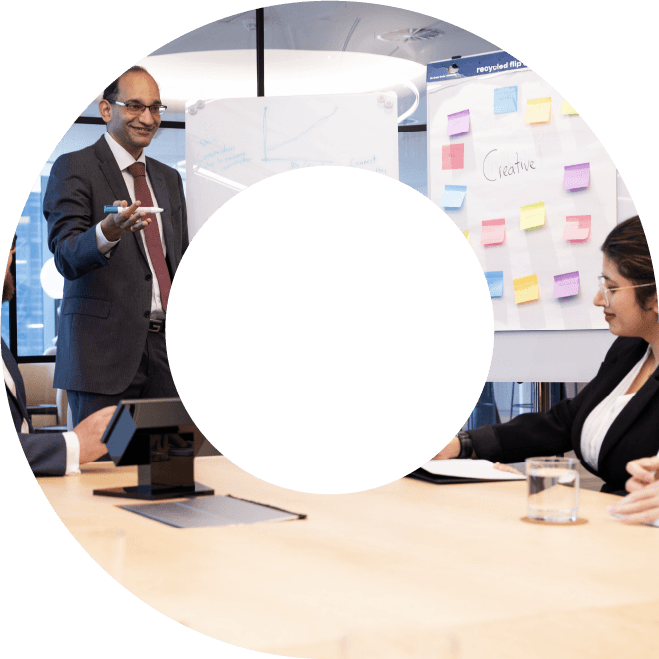 Viewfinder containing image of actuaries brainstorming around a whiteboard in a meeting room
