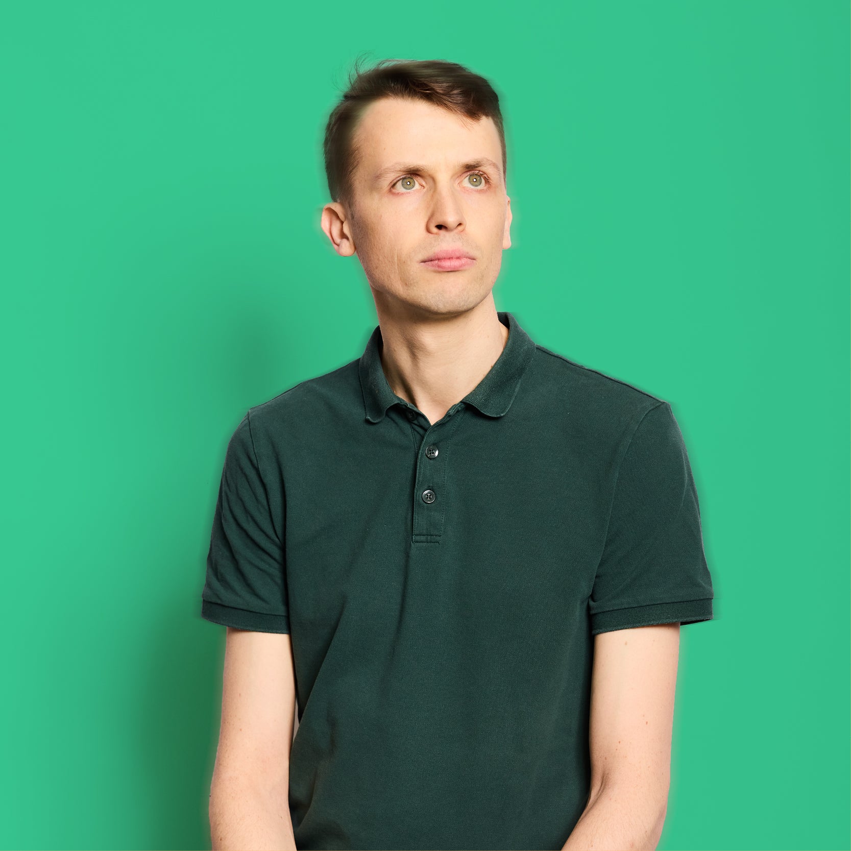 Male in green short on bright green background