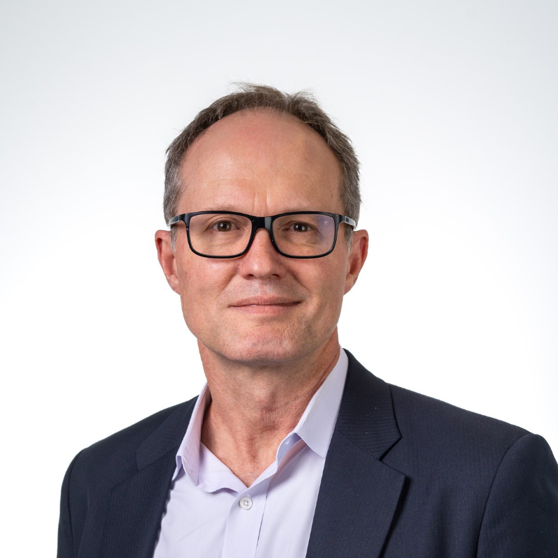 Man in business suit and glasses looking at camera