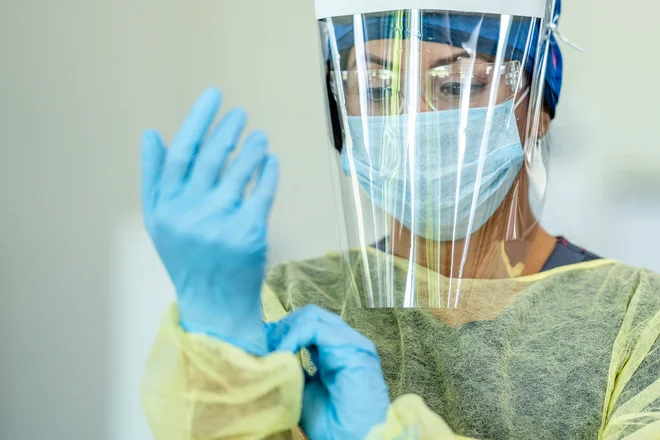 Close up of a female doctor wearing personal protective equipment (PPE) during the COVID-19 outbreak to protect from the transfer of germs.