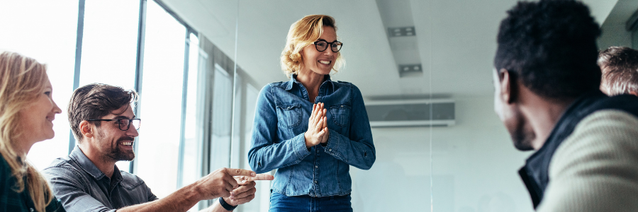 Woman presenting in front of group. 