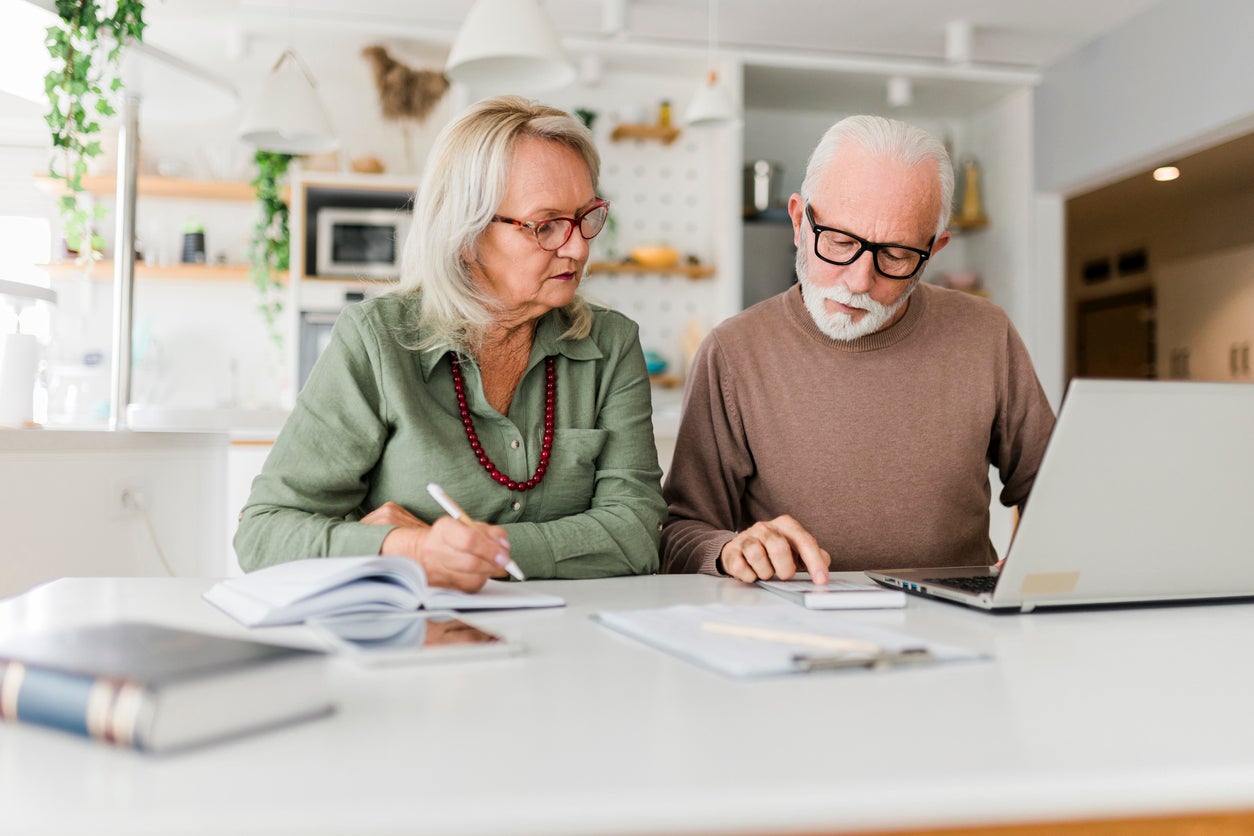 Couple using laptop while planning their home budget
