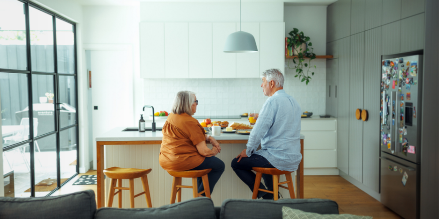 Senior couple having breakfast at home together